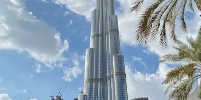 The Burj Khalifa framed by palm fronds against a blue sky