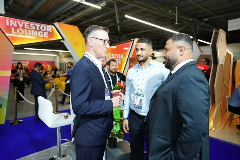 Delegates in conversation beside the Investor Lounge